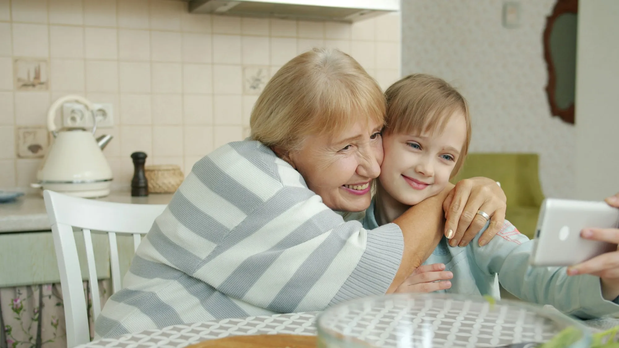 Two people talking across a kitchen table