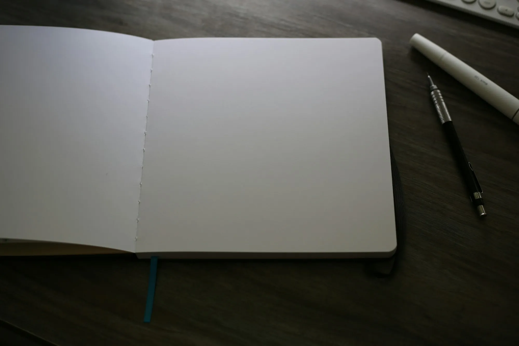 An open notebook and pen on a desk