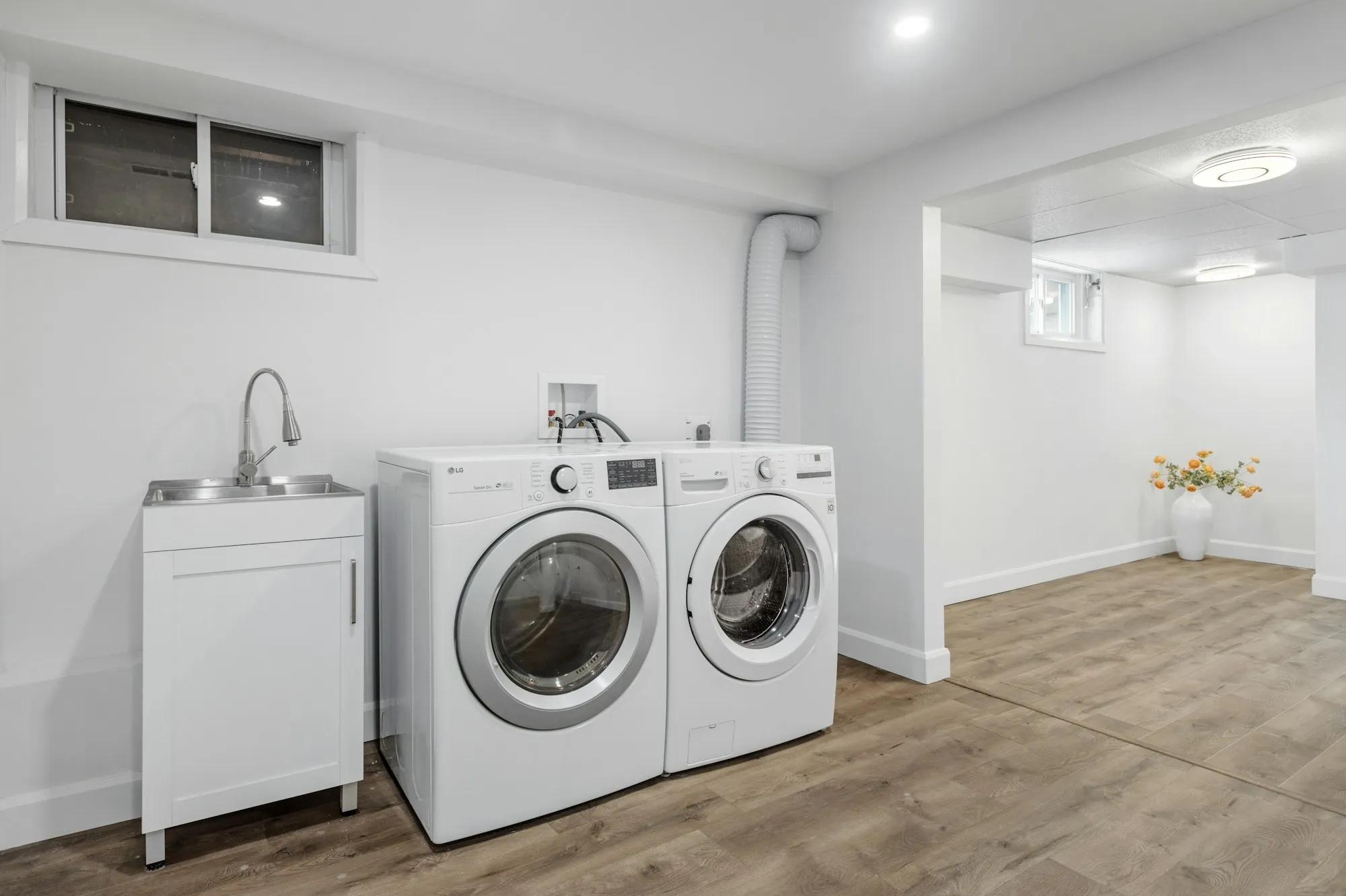 A tidy utility room with a washing machine